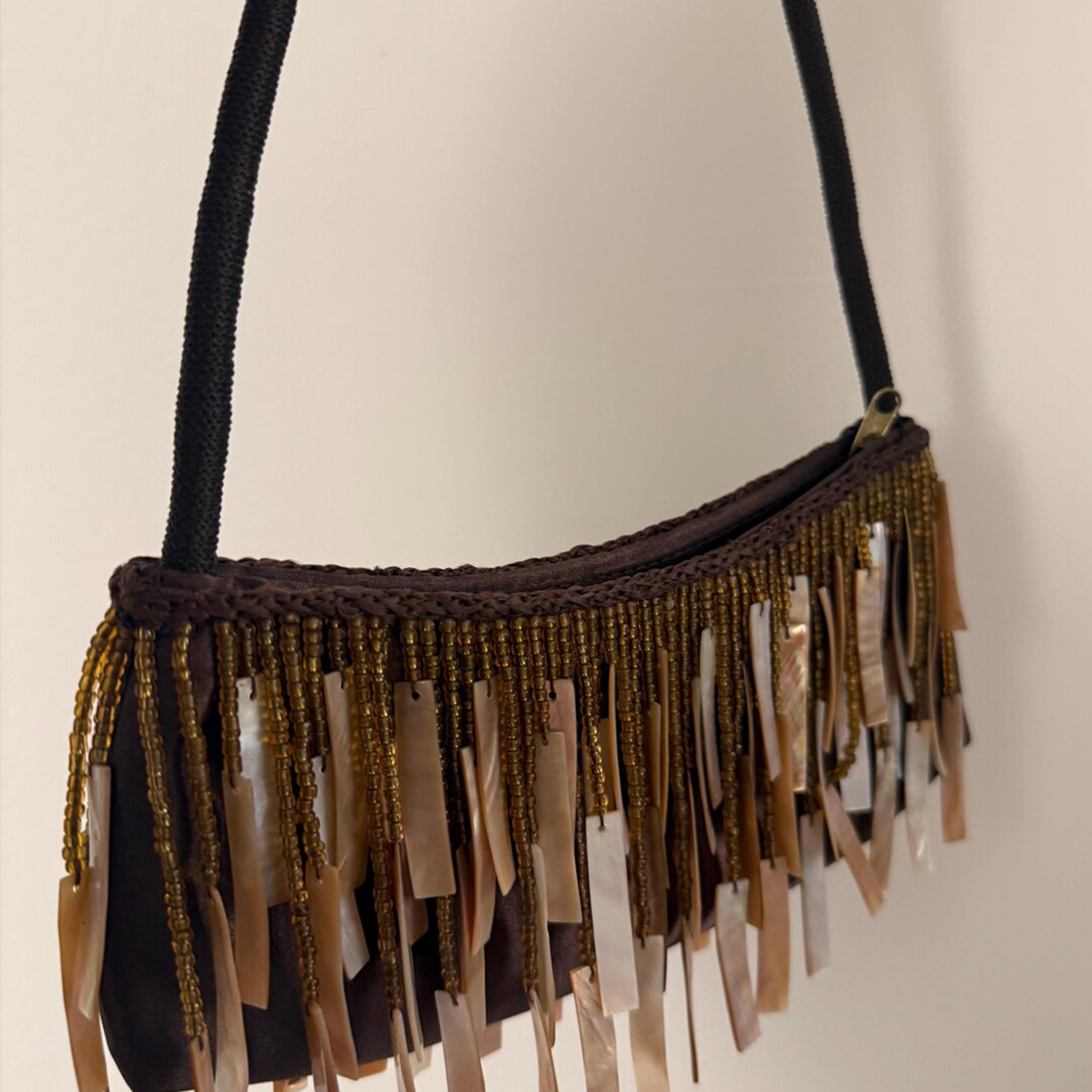 Warm Brown Glossy Silk Curved Shoulder Pouch With Layered Golden Seed Bead & Polished Seashell Slab Fringe Trim And Wrapped Fabric Single Shoulder Strap