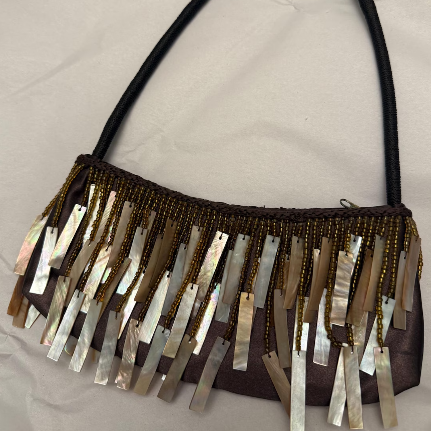 Warm Brown Glossy Silk Curved Shoulder Pouch With Layered Golden Seed Bead & Polished Seashell Slab Fringe Trim And Wrapped Fabric Single Shoulder Strap